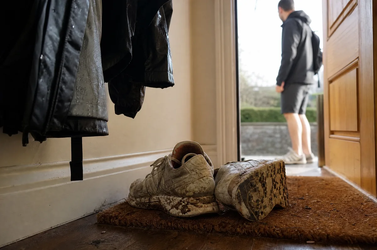 Muddy trainers on the doormat.